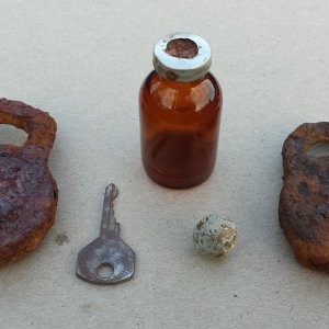 Some relics found where a Civil War Confederate hospital used to be. Included are 2 old locks, a key, an old syringe bottle and a round ball. Alll fou