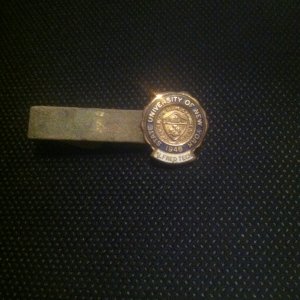 Tie clip, enamel and gold. Back is marked 10K. Front is dated 1948. Very cool!