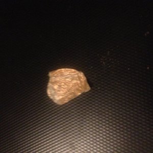A piece of tinfoil or tinfoil top of some sort