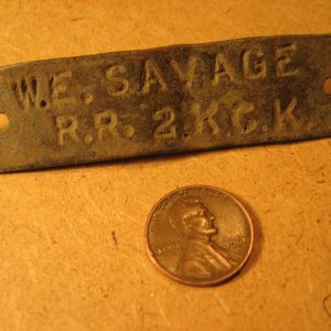 Hand-stamped brass tag found on former farm site in eastern KS (front).