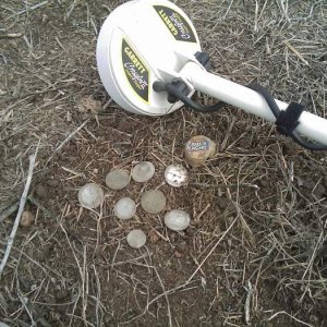 Garrett sniper find - this was a small cache of a few quarters,nickels and dimes all found insde of that bottle cap. only i quarter was outside the ca