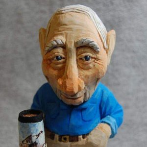 My Dad - A caricature carving I did of my dad.  He always drinks tea.  I had him holding his glass with a few dribbles on the base.  I called it the "