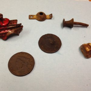 2 Large Cents (one from 1828)
toy fire truck
home made lead sinker
metal push pin (early 1900's)
possibly a window shade holder