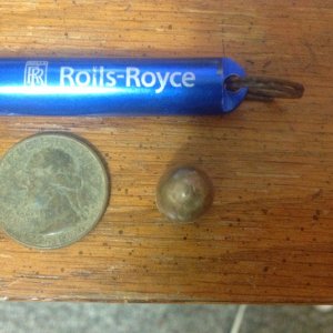 A Bicentennial quarter, 45 ACP projectile and a rolls Royce thingy