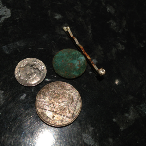 American dime, 10 pence and 1 England penny. Then a hair pin