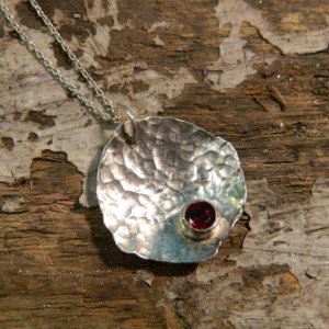 Textured sterling silver and garnet pendant