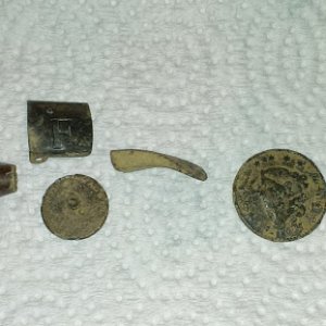 50 cal slug. Suspender clip, 1800's Wallace flat button, Gun trigger, 1827 Large cent.  
   Northville
