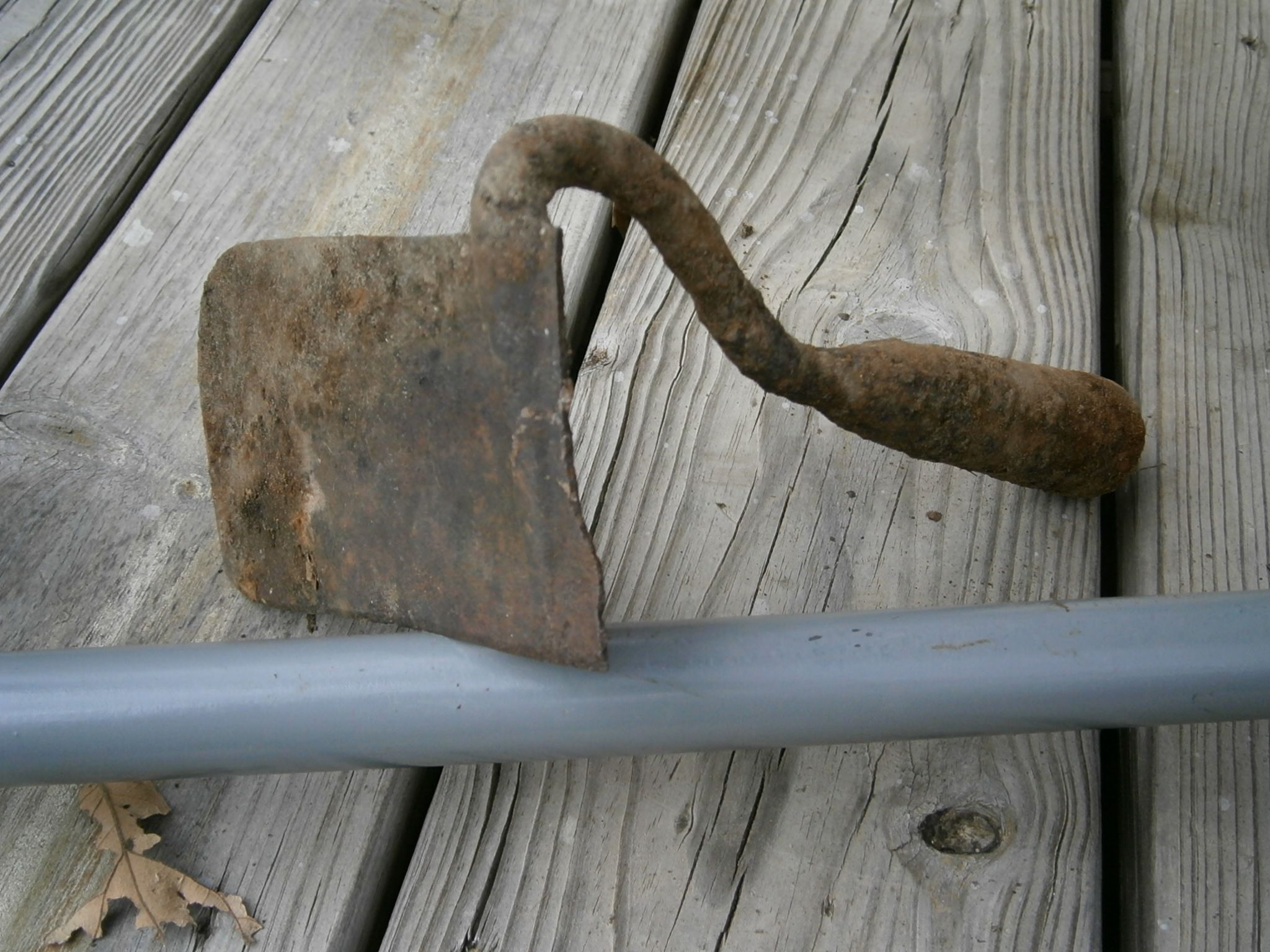 half a garden hoe, well worn and filed blade concave