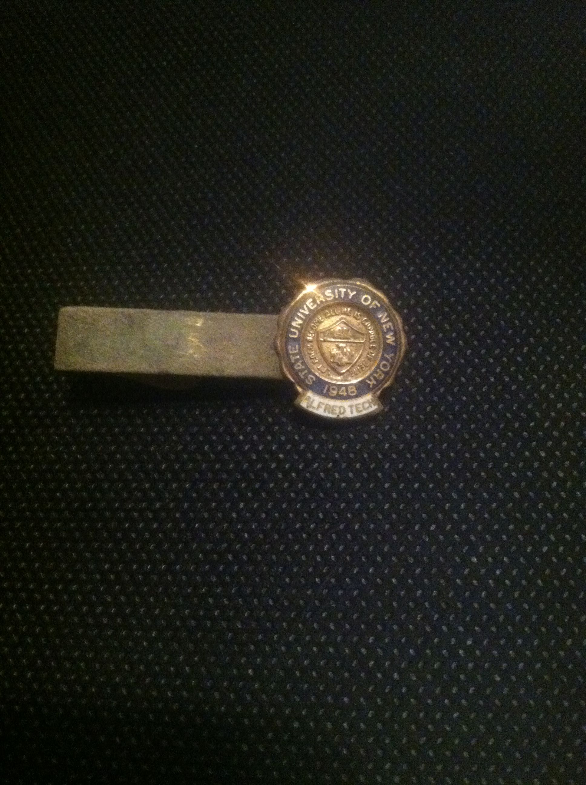 Tie clip, enamel and gold. Back is marked 10K. Front is dated 1948. Very cool!