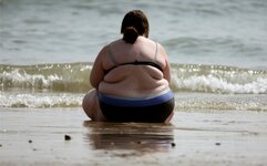 Fat woman sitting on beach.jpg