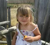 mati eating apricot in the garden.webp