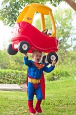 A Little Boy Wearing A Superman Muscle Costume.jpg