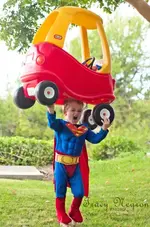 A Little Boy Wearing A Superman Muscle Costume.webp