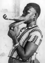 Extended_mouthpiece_for_pipe_smoking_woman.webp
