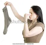 stock-photo-woman-with-dirty-sock-holding-her-nose-on-a-white-background-100696768.webp