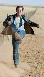 Man-on-a-ranch-kicking-dirt.webp