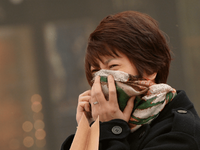 A-Chinese-woman-tries-to-protect-herself-as-Beijing-is-hit-by-a-sandstorm-Getty-640x480.png