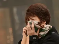 A-Chinese-woman-tries-to-protect-herself-as-Beijing-is-hit-by-a-sandstorm-Getty-640x480.webp