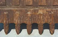 47046826-teeth-of-excavator-bucket-as-artistic-construction-machinery.webp