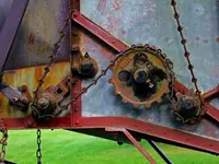 chain_and_gear_system_on_antique_harvester.webp
