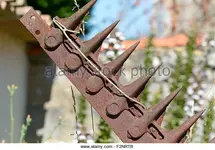 rusty-old-farm-plough-with-sharp-blades-in-french-countryside-f2nrtb.webp