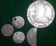 coins from Spain one has been cut to make small change.webp