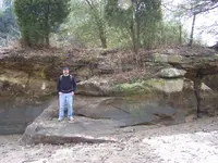 Dex at bottom of line of rocks.webp