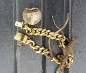 rob gold bracelet on truck.webp