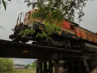 train by creek.webp