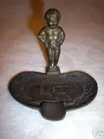 1930-s-swastika-ashtray-with-boy-peeing-brass_1_a688c61a5a3703409827302163bf7cc3.webp