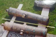 2 bronze quarter canons and silver bar.webp