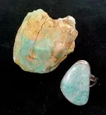 Amazonite ring next to raw stone.webp