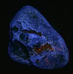 agate looking rock with orange fl.webp