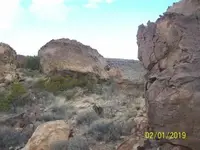Dog Man Head Boulder with Tunnel into Cave Beneath it.webp