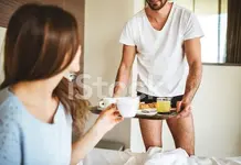 Tom serving wife coffee in bed.webp
