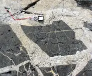 1200px-White_granite_intruding_black_basalt.webp