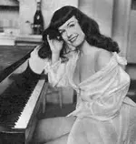 Bettie Page at piano.webp