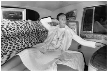 marisa-berenson-seated-in-the-back-of-a-car-with-leopard-seats-wearing-white-chanel-ensemble-...webp