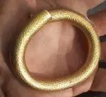 Gold-torque-in-hand-e1570548149261-150x138.webp