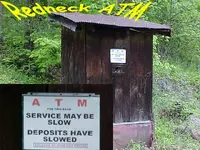 Redneck ATM yellow sign.webp