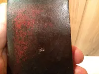 red paint axe head stamped E 004.webp