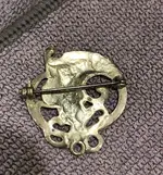 back of pin women with flowing hair lily on head.webp