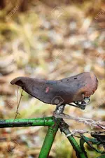 49576508-old-leather-seat-of-a-bicycle-worn-saddle.webp