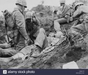 wounded-soldier-given-blood-plasma-between-motoyama-airstrip-2-and-purple-beach-on-d-plus-3-day-.jpg