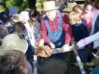kids with corn shucker.webp