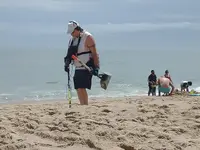 Me metal detecting on beach.webp