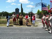 2. Placing wreath in honor of Battle of Medina.webp