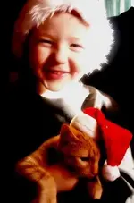 Evan  & kitten  in Santa hats.webp