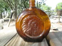 Glass bottle with Indian chief.webp