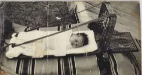 kim in cradle board.webp